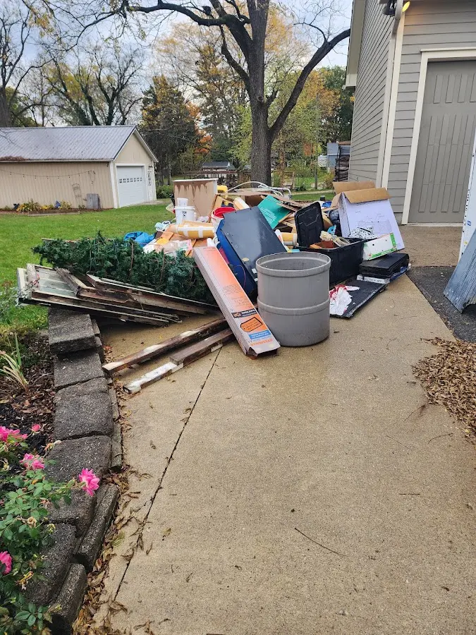 Dumpster being loaded with debris for 3 Yard Dumpster Rental in Twin Lakes